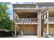 Charming brick townhome with a covered balcony above the two-car garage offering additional outdoor living space at 2520 Carmel Way, Alpharetta, GA 30009