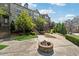 Townhome exterior with brick facade, landscaped grounds, and a communal fire pit at 2520 Carmel Way, Alpharetta, GA 30009