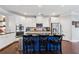 Modern kitchen with an island, stainless steel appliances, white cabinetry, and a complementary backsplash design at 2520 Carmel Way, Alpharetta, GA 30009
