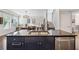 Close-up of kitchen island with stainless steel dishwasher and sink, with the dining area in the background at 2520 Carmel Way, Alpharetta, GA 30009