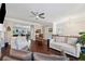 Bright living room featuring hardwood floors, a ceiling fan, and neutral decor with comfortable seating arrangements at 2520 Carmel Way, Alpharetta, GA 30009