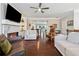 Spacious living room with a fireplace, hardwood floors, and comfortable seating, leading into an open-concept kitchen at 2520 Carmel Way, Alpharetta, GA 30009