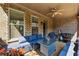 Covered brick patio with comfortable seating, ceiling fan, and outdoor cooking area at 2520 Carmel Way, Alpharetta, GA 30009