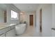 Elegant bathroom featuring a soaking tub, and a shower at 117 Compass Rd, Hampton, GA 30228