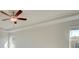 Bedroom featuring a ceiling fan, tray ceilings, and neutral walls at 117 Compass Rd, Hampton, GA 30228