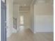 Bright entryway with hardwood floors, white wainscoting, and a staircase with decorative iron spindles at 117 Compass Rd, Hampton, GA 30228