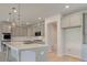 Well-lit kitchen featuring an island, pendant lights, and stainless steel appliances at 117 Compass Rd, Hampton, GA 30228