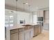 Modern kitchen island with stainless steel appliances adjacent to a living area at 117 Compass Rd, Hampton, GA 30228