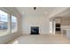 Open living area featuring a fireplace and multiple windows for natural light at 117 Compass Rd, Hampton, GA 30228