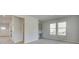 Open concept living room featuring an office nook, large windows, and neutral color palette at 117 Compass Rd, Hampton, GA 30228