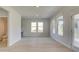 Bright, airy living room with an open floor plan featuring a water closet, large windows and tile flooring at 117 Compass Rd, Hampton, GA 30228