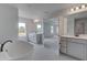Bathroom view showcasing dual vanities, modern fixtures, and a standalone tub at 145 Compass Rd, Hampton, GA 30228