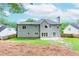 View of the rear exterior showcasing a well-maintained yard and neutral colored siding at 2115 Bentbrooke Trl, Lawrenceville, GA 30043