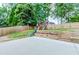 Spacious backyard with a playset, green grass, wooden retaining walls, and mature trees at 2115 Bentbrooke Trl, Lawrenceville, GA 30043