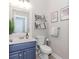Charming bathroom with blue vanity, updated fixtures, and decorative accents at 2115 Bentbrooke Trl, Lawrenceville, GA 30043