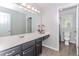 This bathroom is equipped with a single sink vanity, drawers, and a view of the toilet and shower at 2115 Bentbrooke Trl, Lawrenceville, GA 30043