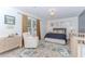 Stylishly decorated bedroom with a chair, vibrant rug, and ample natural light at 2115 Bentbrooke Trl, Lawrenceville, GA 30043