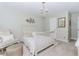 This neutral bedroom features soft decor, a light fixture, and stylish accents at 2115 Bentbrooke Trl, Lawrenceville, GA 30043