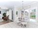 Bright breakfast nook with large windows, white chairs, and a view of the backyard at 2115 Bentbrooke Trl, Lawrenceville, GA 30043