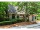 Exterior view of community clubhouse surrounded by lush landscaping and mature trees at 2115 Bentbrooke Trl, Lawrenceville, GA 30043