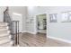 Elegant foyer with wood flooring and staircase, offering a view into the home office space with lots of natural light at 2115 Bentbrooke Trl, Lawrenceville, GA 30043