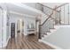 Inviting foyer with wood flooring, a staircase with wrought iron railings, and bright, neutral walls at 2115 Bentbrooke Trl, Lawrenceville, GA 30043