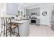 Updated kitchen with gray cabinets, stainless appliances, granite countertops, and tile flooring at 2115 Bentbrooke Trl, Lawrenceville, GA 30043