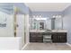 The bright main bathroom features tile flooring, a glass shower, and a double sink vanity at 2115 Bentbrooke Trl, Lawrenceville, GA 30043