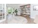 Bright home office featuring a large bay window, stylish shelving, and light wood floors, perfect for work or study at 2115 Bentbrooke Trl, Lawrenceville, GA 30043