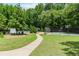 Community tennis court with mature trees, sidewalks, and well-kept landscaping at 2115 Bentbrooke Trl, Lawrenceville, GA 30043