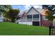 A beautiful backyard featuring a well-maintained lawn and a screened-in porch at 3737 Falls Trl, Winston, GA 30187