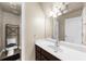 Bathroom featuring a modern vanity, large mirror, and a conveniently located toilet at 3737 Falls Trl, Winston, GA 30187