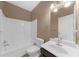Neutral bathroom featuring a tub/shower combination with a dark wood vanity at 3737 Falls Trl, Winston, GA 30187