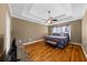 Bedroom featuring tray ceilings, hardwood floors, and a plush bed at 3737 Falls Trl, Winston, GA 30187