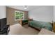 Cozy bedroom featuring twin beds, neutral carpet, ceiling fan, and a bright window at 3737 Falls Trl, Winston, GA 30187