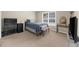 Comfortable bedroom with modern desk, neutral carpet, bed and large window at 3737 Falls Trl, Winston, GA 30187