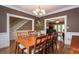 Elegant dining room with hardwood floors, a chandelier, and views into the living area at 3737 Falls Trl, Winston, GA 30187