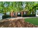 Beautiful brick home featuring manicured landscaping, a pathway to the front door, and lush green lawn at 3737 Falls Trl, Winston, GA 30187