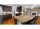 Modern kitchen featuring granite countertops, dark wood cabinets, and an open design at 3737 Falls Trl, Winston, GA 30187