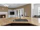 Kitchen view showcasing the fireplace, island sink, and exterior view at 3737 Falls Trl, Winston, GA 30187
