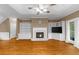 Cozy living room showcases hardwood floors, a fireplace, built-in shelving, and natural light at 3737 Falls Trl, Winston, GA 30187