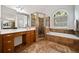 Primary bathroom featuring double vanity, soaking tub, and glass enclosed shower at 7198 Golfside Se Dr, Covington, GA 30014