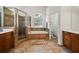 Bathroom featuring a soaking tub, glass-enclosed shower, tile floors, and double vanity at 7198 Golfside Se Dr, Covington, GA 30014