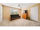 Comfortable bedroom featuring a futon, ceiling fan, closet and bright window at 7198 Golfside Se Dr, Covington, GA 30014