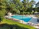 Community pool area featuring lounge chairs, umbrellas, and a refreshing swimming pool at 7198 Golfside Se Dr, Covington, GA 30014