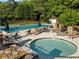 Inviting community pool and spa area surrounded by lounge chairs and landscaped greenery at 7198 Golfside Se Dr, Covington, GA 30014