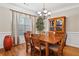 Elegant dining room with hardwood floors, chandelier, and traditional furniture at 7198 Golfside Se Dr, Covington, GA 30014
