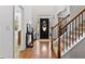 Foyer with hardwood flooring, staircase and console table at 7198 Golfside Se Dr, Covington, GA 30014