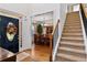 Foyer with hardwood flooring, dining room view and staircase at 7198 Golfside Se Dr, Covington, GA 30014