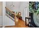 Inviting foyer featuring hardwood floors, staircase, and a view into the living room at 7198 Golfside Se Dr, Covington, GA 30014